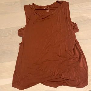 burnt orange tank with cut outs on the side